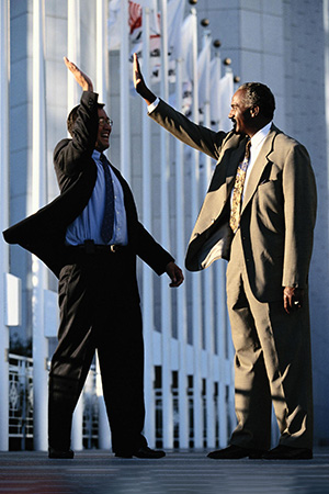 Businessmen high-fiving one another