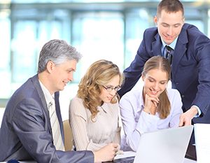 Business people looking at a computer screen