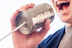 A man talking through a tin can